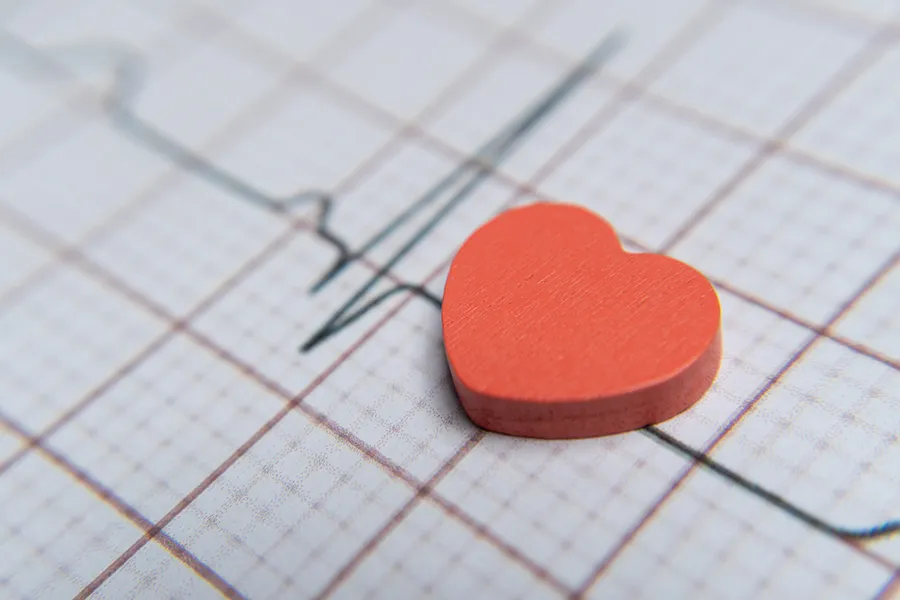 Close up of a red heart on an ECG printout.